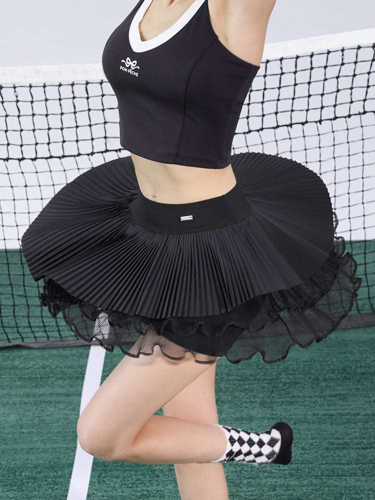Black pleated tennis skirt with layered mesh and wide flare for court movement
