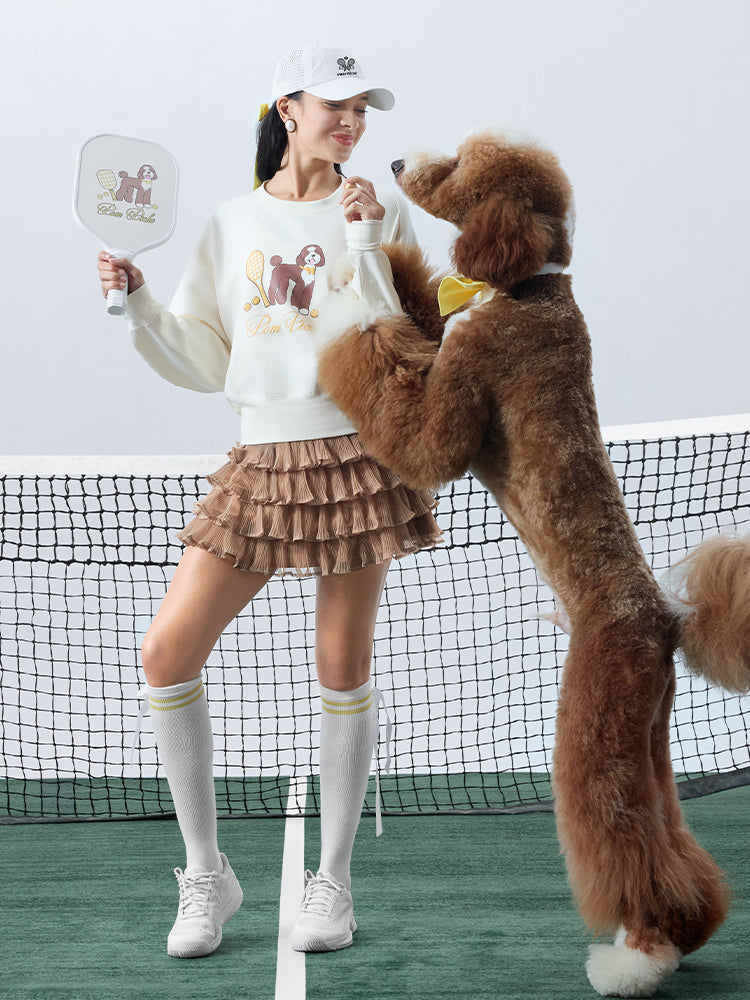 Soft, casual sweatshirt featuring a playful dog-and-tennis graphic, perfect for relaxed, sporty looks.
