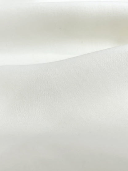 Close-up of cream sweatshirt's fabric material. 