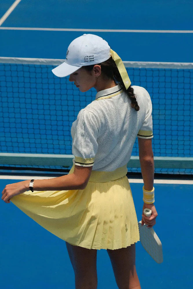 Woman in tennis attire on a blue court