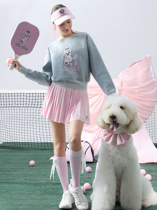 Soft, casual gray sweatshirt featuring a playful dog-and-tennis graphic, perfect for relaxed, sporty looks.