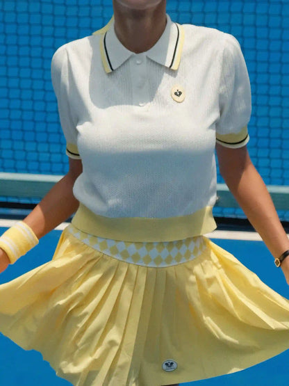 Person wearing a white polo shirt with yellow accents and a yellow skirt on a blue background