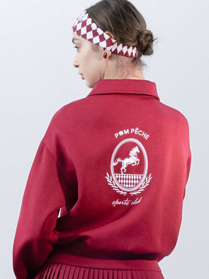 Red sweatshirt with quarter-zip design and embroidered logo on the front and back, offering a stylish and sporty look.